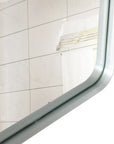 Close-up of the Lunare bathroom mirror showing its silver aluminum frame, rounded corner, and beveled edge.