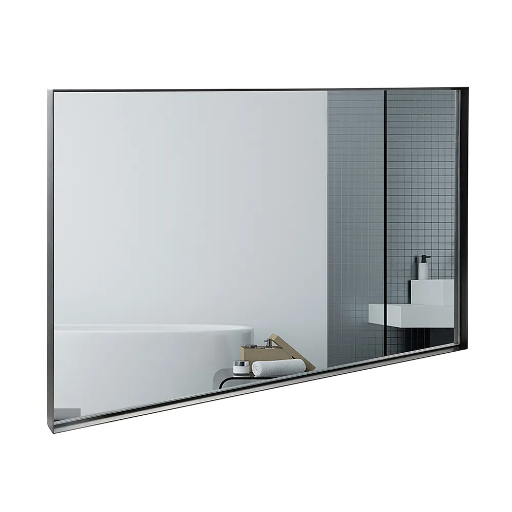 Noir Series black metal frame mirror on white background, reflecting a modern bathroom with bathtub, vanity, and gray subway tile.
