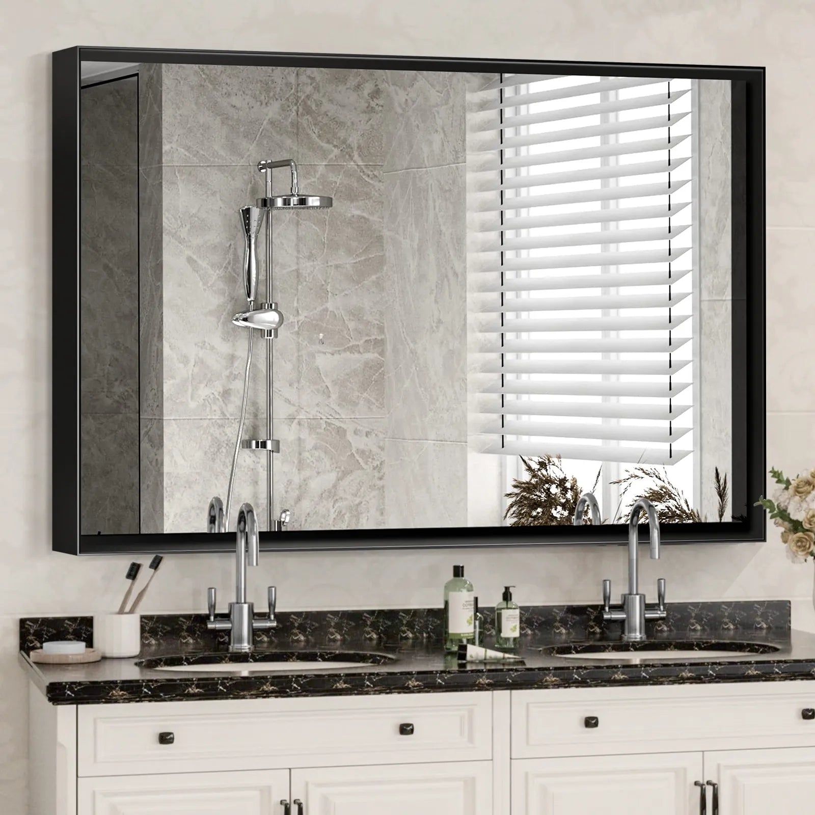 Noir black rectangular metal frame mirror with beveled edge in a modern bathroom setting, mounted above a white double vanity.