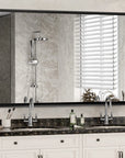 Noir black rectangular metal frame mirror with beveled edge in a modern bathroom setting, mounted above a white double vanity.