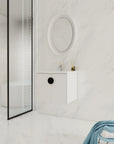 24 inch white floating bathroom vanity with black round handle in a minimalist bathroom | Ace Decor