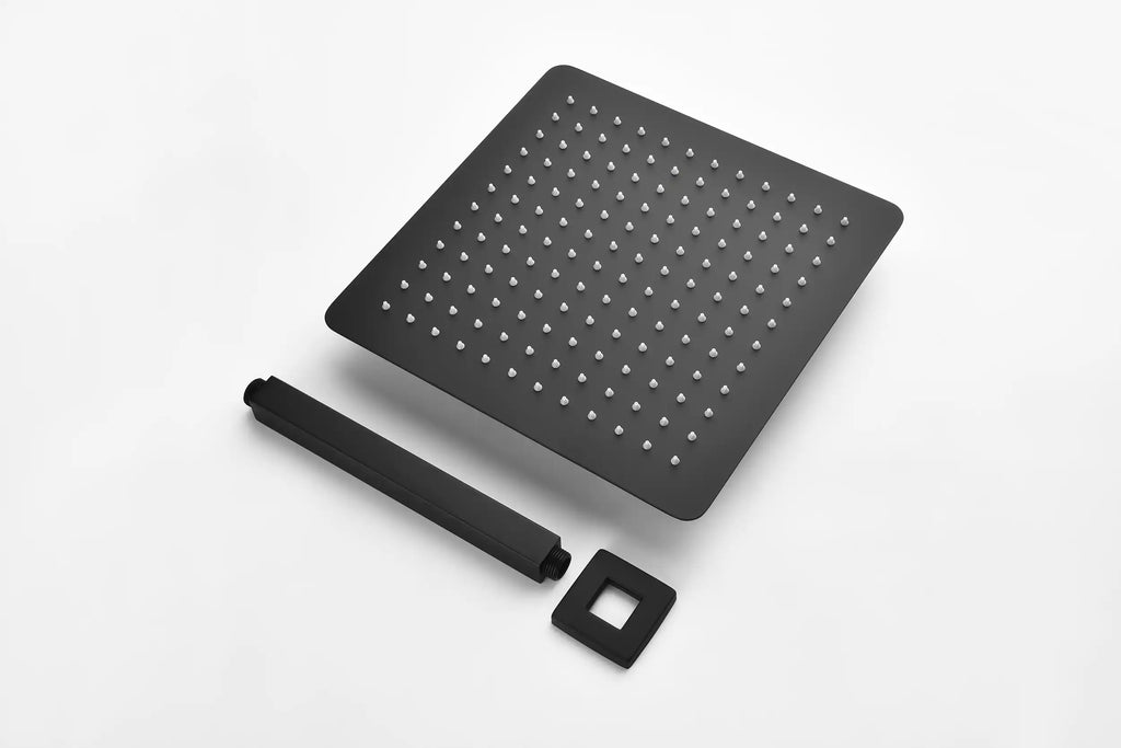 Matte black square showerhead with silicone nozzles, sleek shower arm, and wall plate for modern bathroom design.