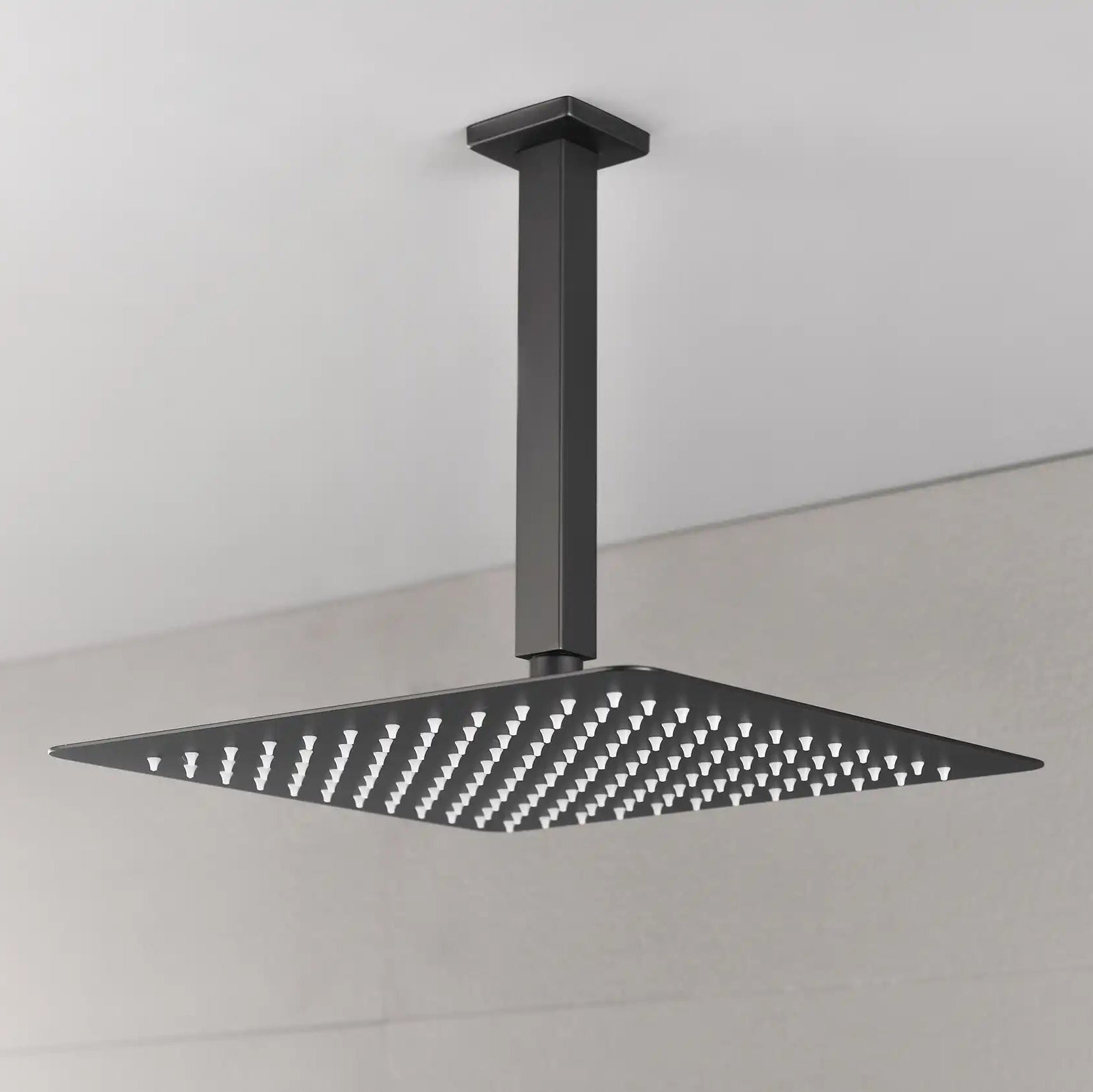 Modern bathroom view showing the Lorton 12" black rain shower head mounted overhead with a wide spray area.