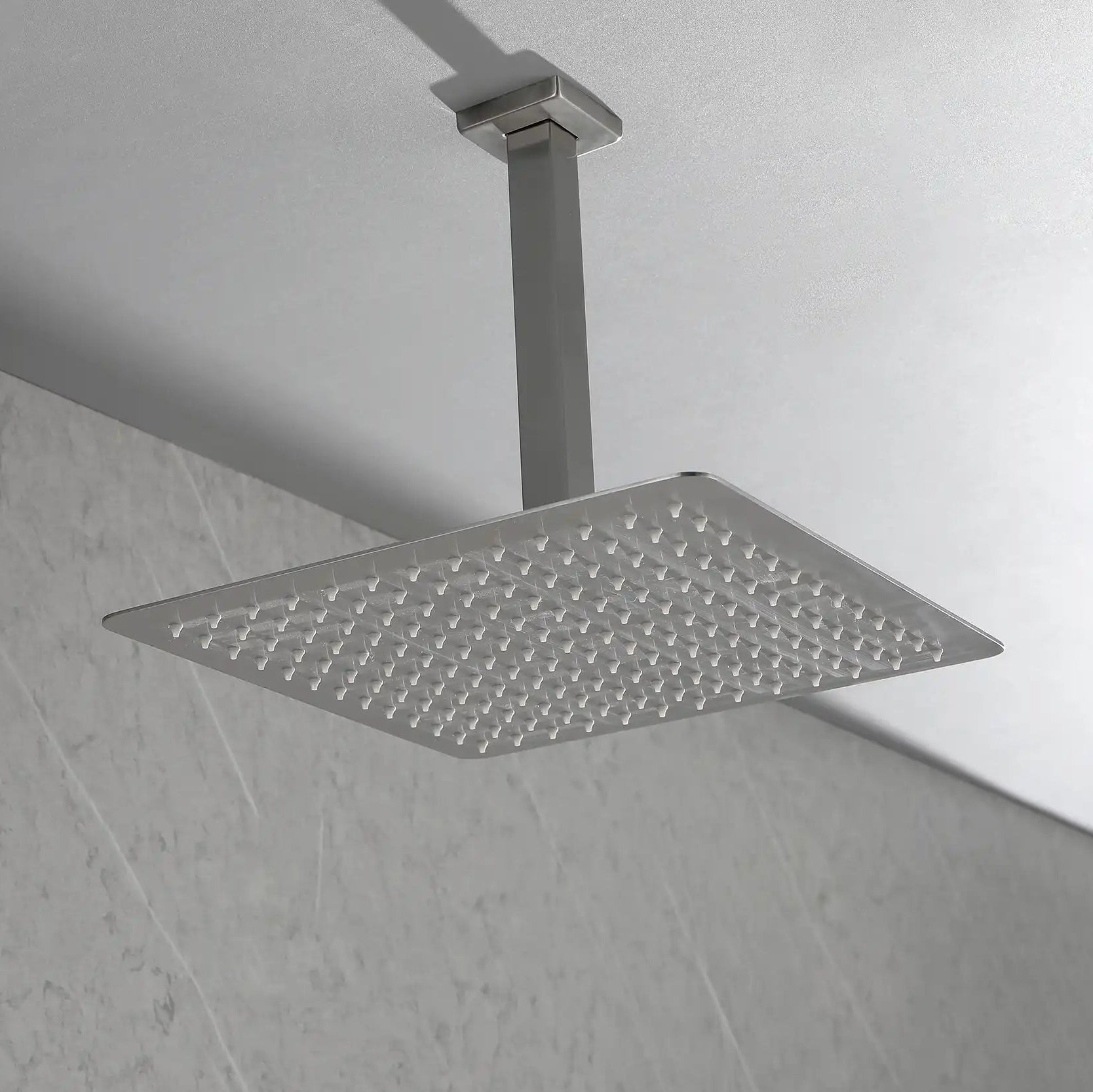 Side-angle bathroom scene with the Lorton brushed nickel 12" rain shower head mounted from above.