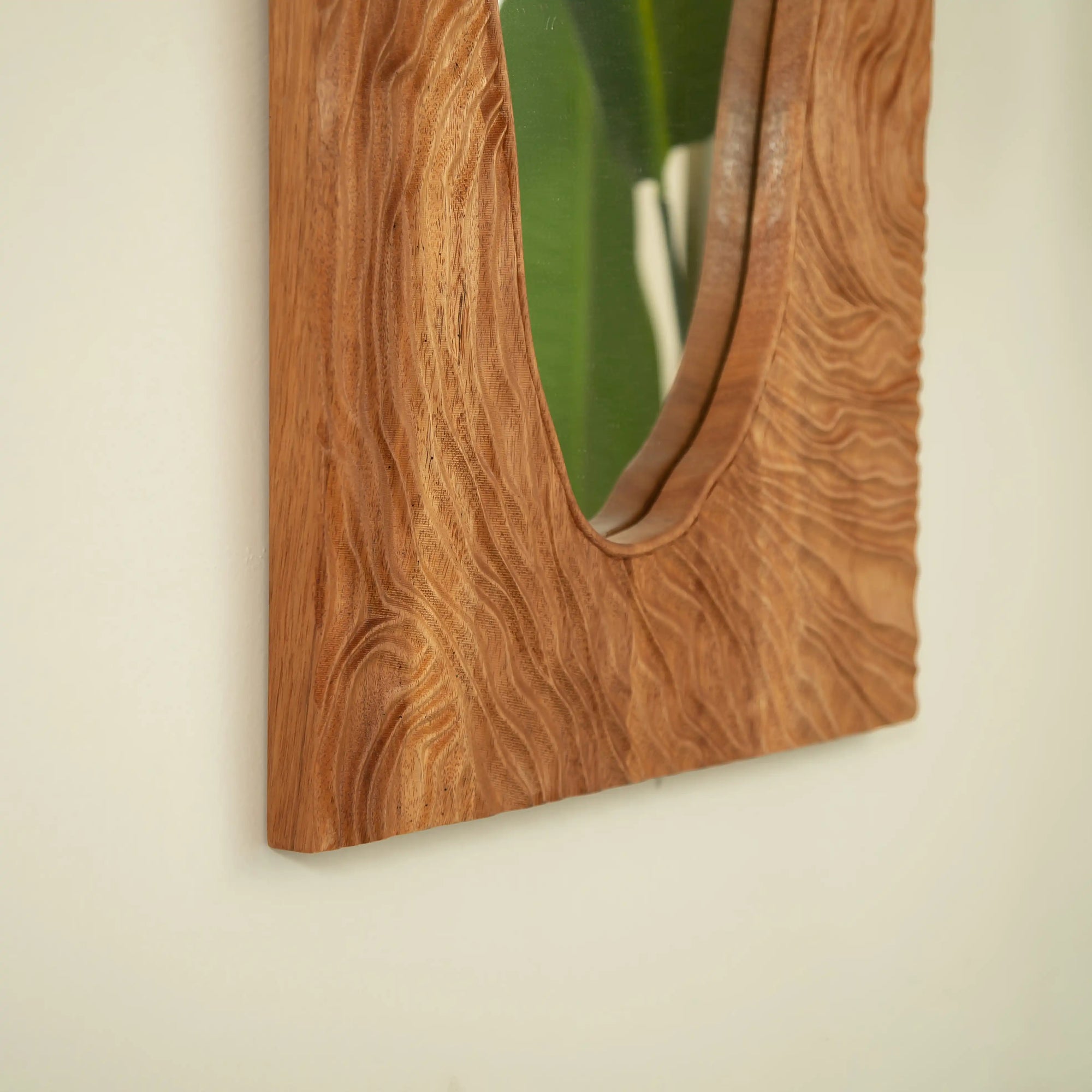 Side view of a wood vanity mirror showing the unique natural rosewood grain with an organic handcrafted finish.