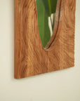 Side view of a wood vanity mirror showing the unique natural rosewood grain with an organic handcrafted finish.