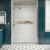 Front view of chrome framed pivot shower door with clear glass and watertight seals, in a modern bathroom.