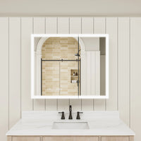Double-door LED medicine cabinet with lights on above bathroom sink.