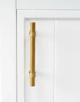 20" white bathroom vanity with gold finish metal handle detail.