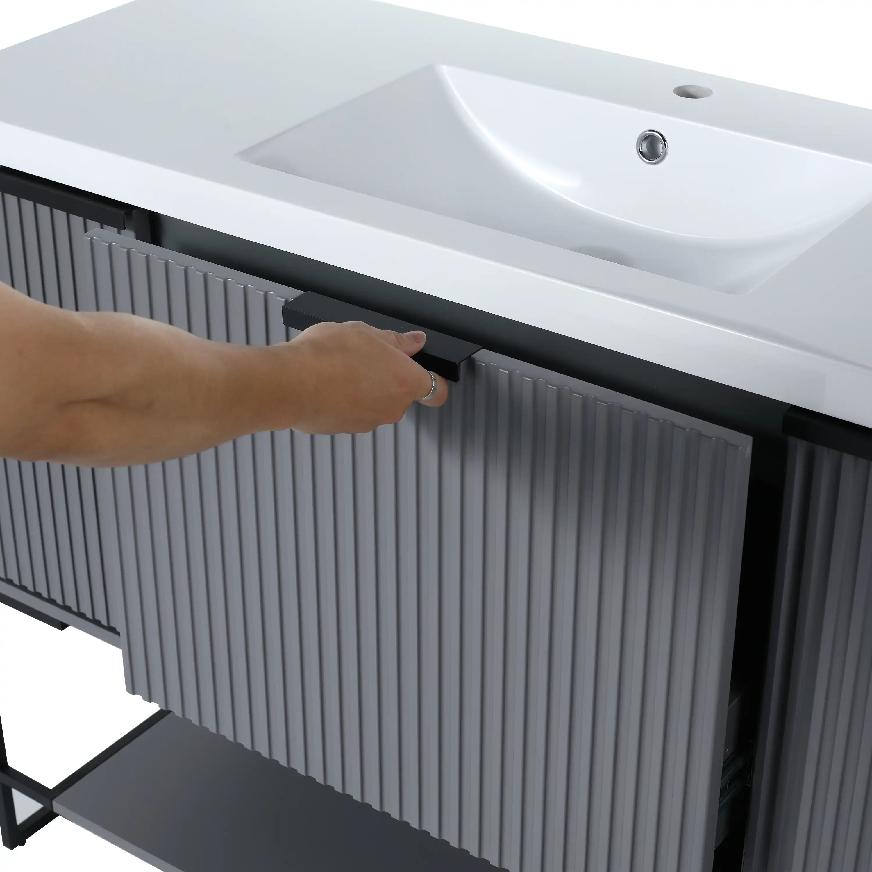 Black metal handle and fluted door panel of the 48-inch bathroom vanity in rock grey finish.