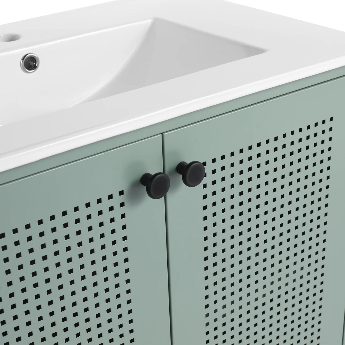 Close up of 30" mint green bathroom vanity with perforated doors and black knobs.