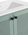 Close up of 30" mint green bathroom vanity with perforated doors and black knobs.