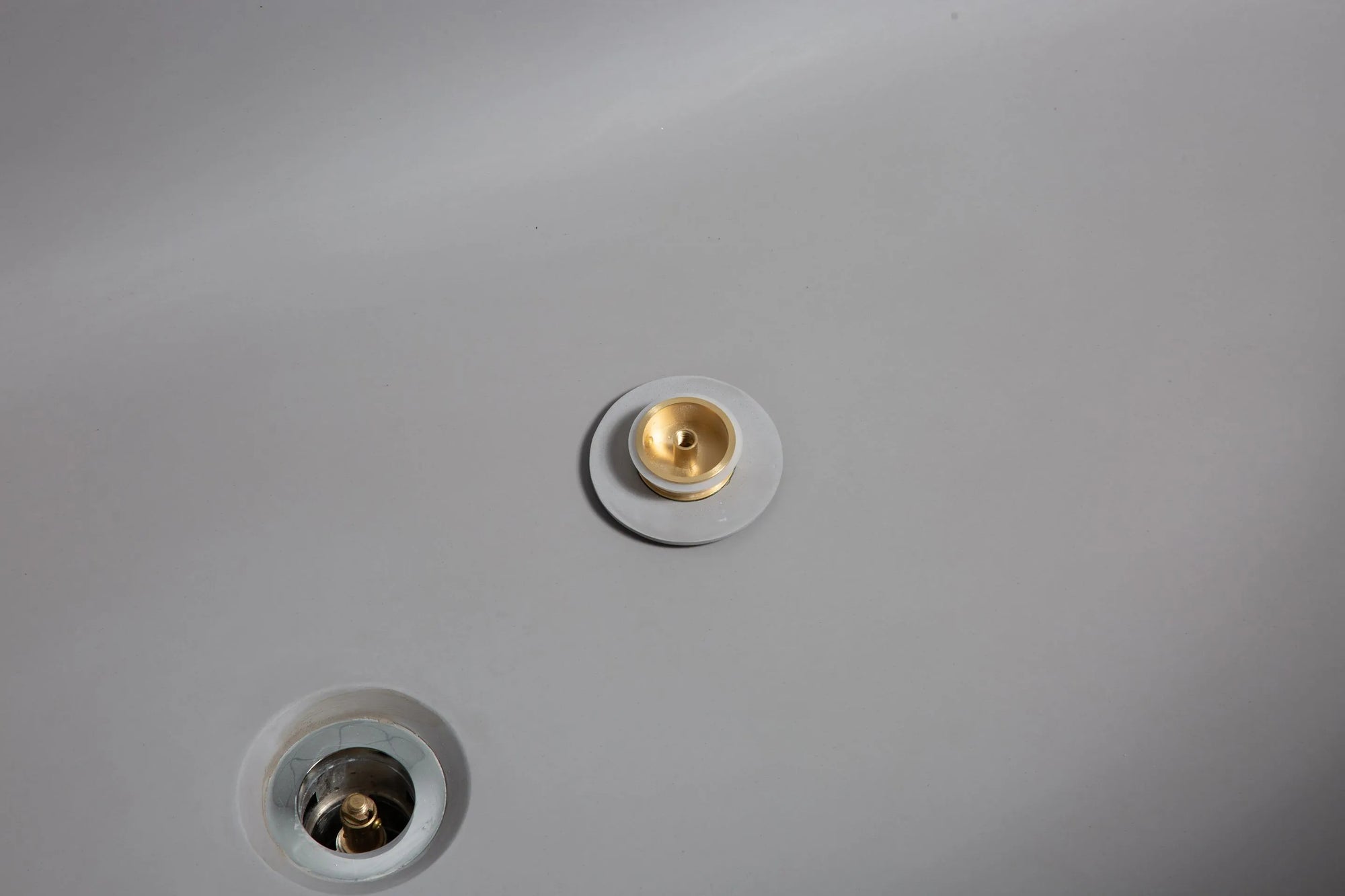 Close-up view of the Nectar Series bathtub drain cover open, revealing the internal metal mechanism.