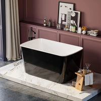 Nectar Series 49x28 inch black  freestanding soaking bathtub on a marble platform in an elegant bathroom with decorative shelf.