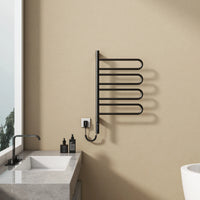 17 x 31 electric towel rack warmer in matte black finish, wall-mounted beside bathroom sink | Ace Decor