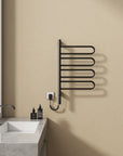 17 x 31 electric towel rack warmer in matte black finish, wall-mounted beside bathroom sink | Ace Decor