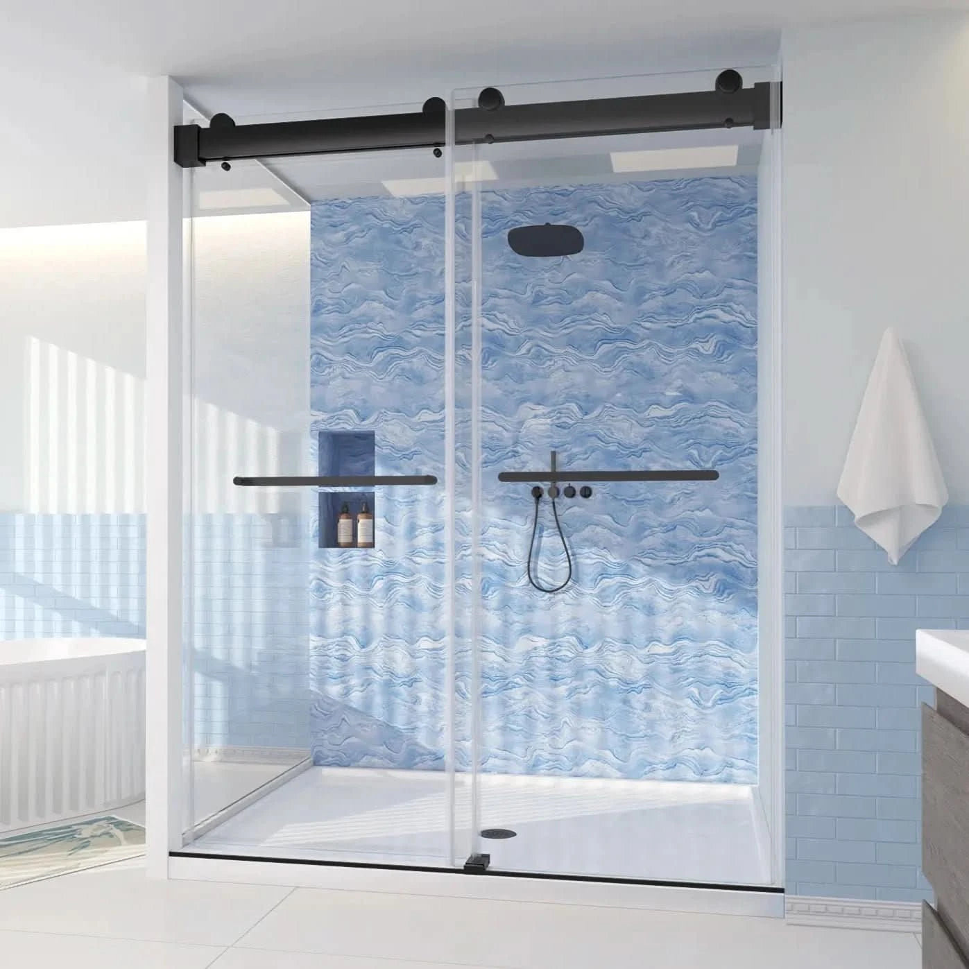 A sleek sliding glass shower enclosure with matte black hardware and a wave-patterned blue tile backdrop | ACE DECOR