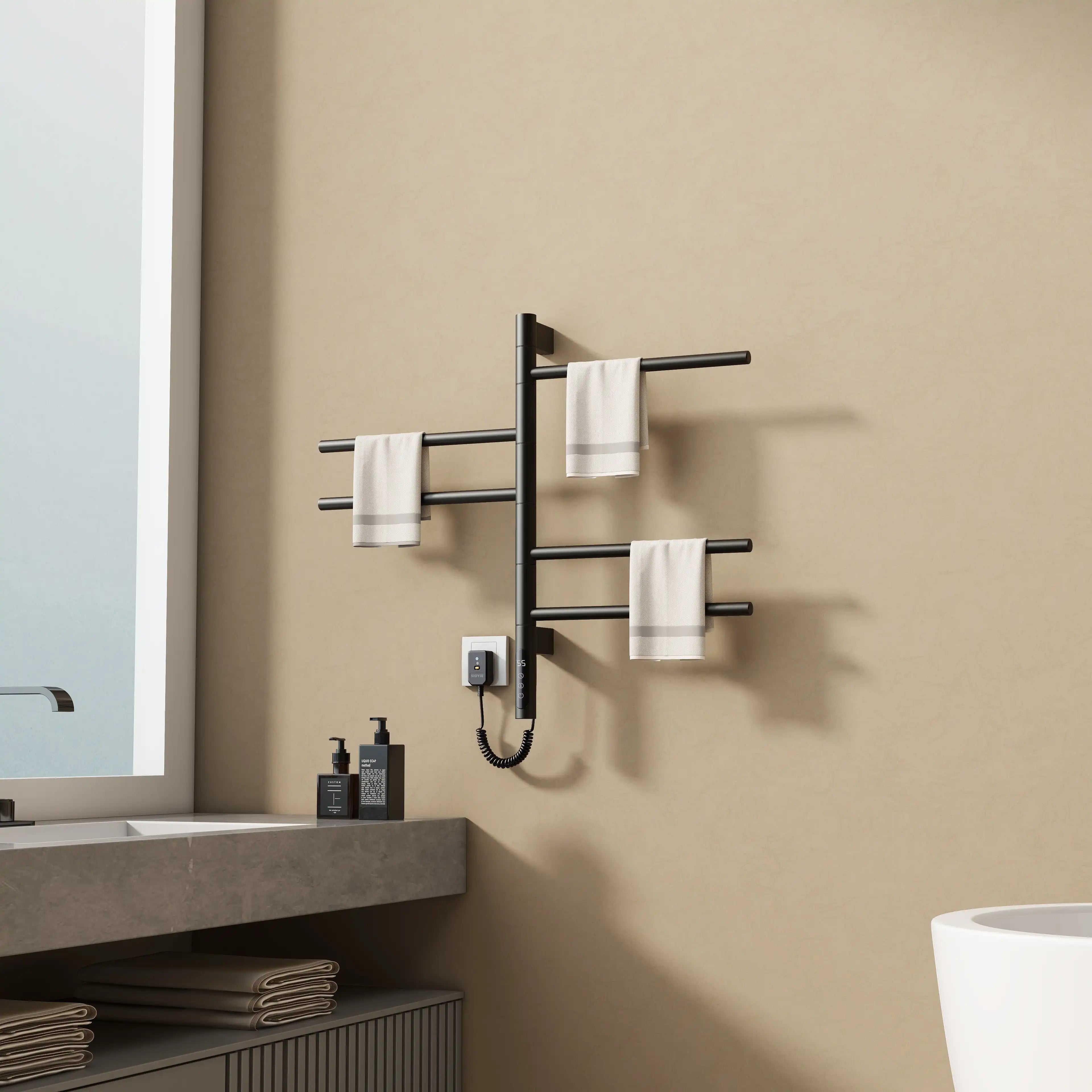 16 x 27 black heated towel rack installed beside a bathroom sink, holding white towels | Ace Decor