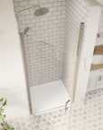 Top-down view of opened chrome framed pivot shower door in a tiled bathroom | Ace Decor