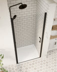 Top-down view of matte black framed pivot shower door opened in a tiled bathroom | Ace Decor