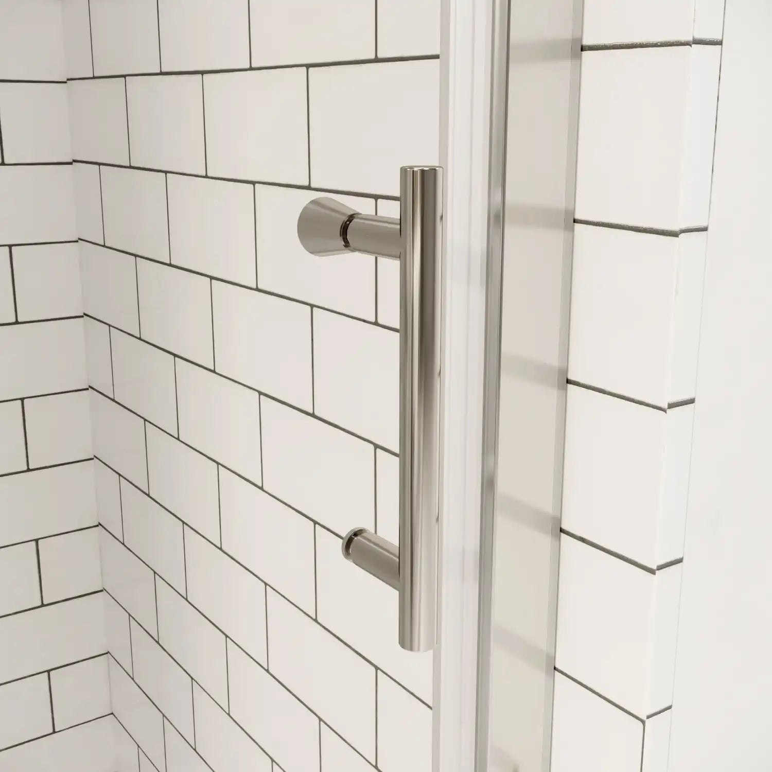 Chrome shower door handle on clear glass with white subway tile background | Ace Decor