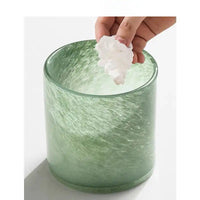 Liuli Glass Brush and Candle Holder with textured green glass finish used as a bathroom storage cup.