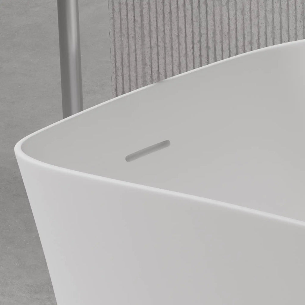 Close-up detail of the 51" solid surface soaking bathtub's sleek overflow drain.