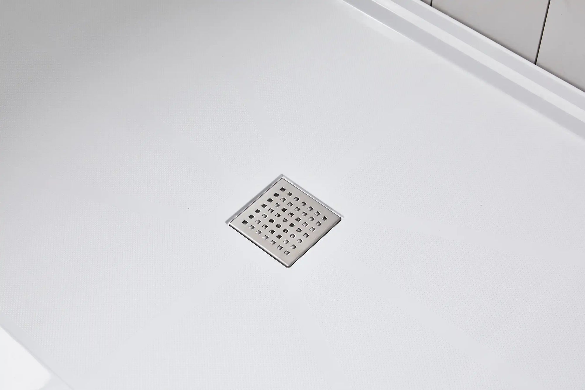 Anti-slip shower base with stainless steel square drain cover for smooth water drainage.