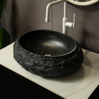 Black stone-textured bathroom sink with smooth ceramic inner basin