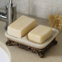 Marseille vintage double soap dish holding two soap bars on a bathroom counter with decorative antique style base.