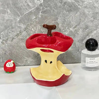 Manzana Collection apple toothbrush storage rack with ceramic apple design for bathroom vanity organization.