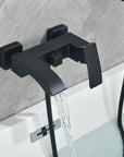 Close-up of the matte black waterfall tub spout with smooth flowing water.
