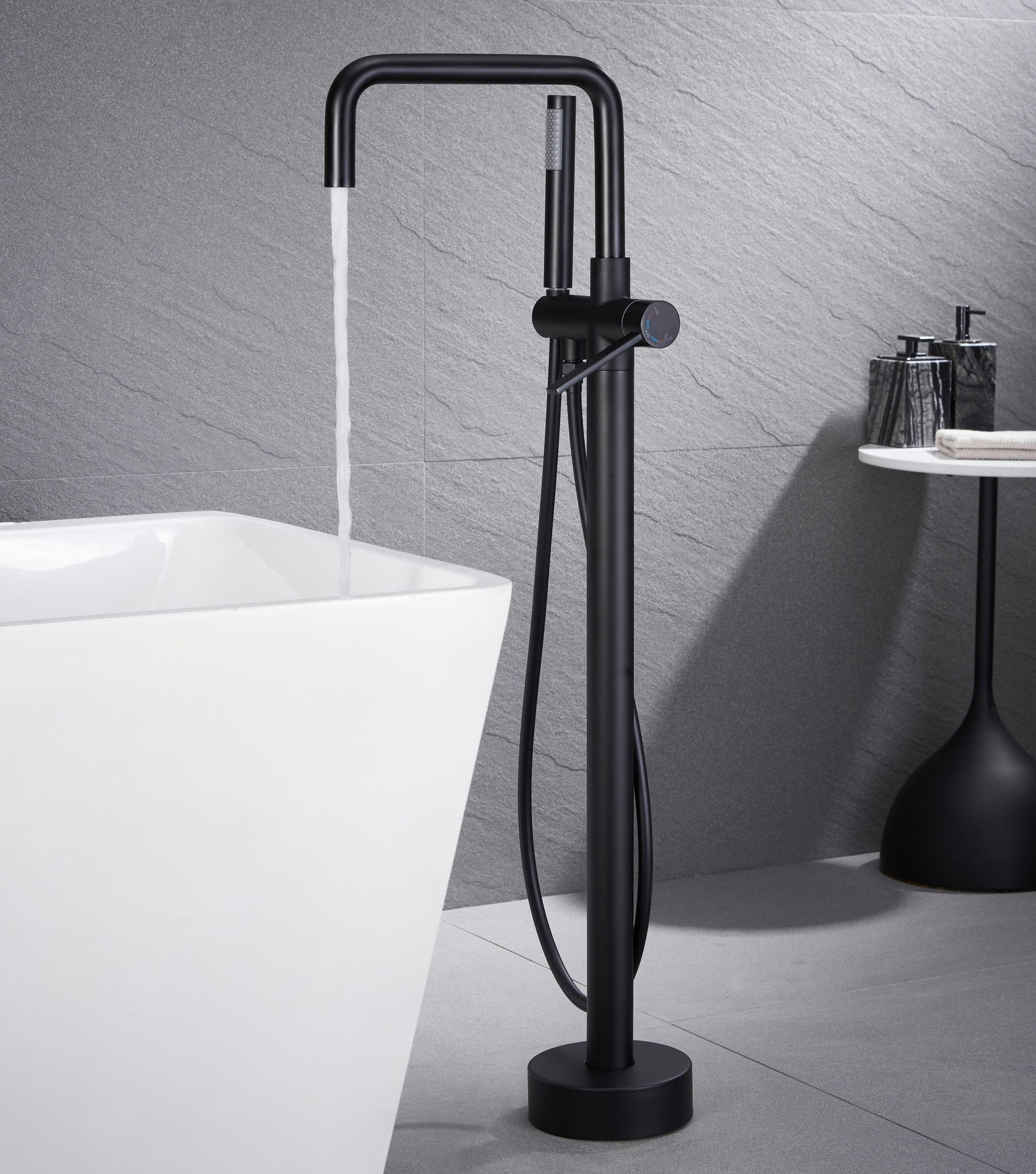 Black Freestanding Tub Faucet filling white bathtub.