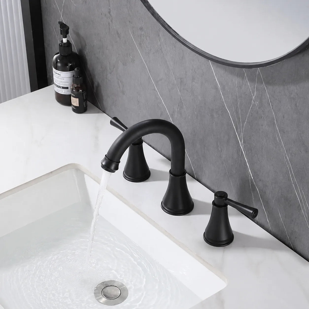 VALMIRA matte black vanity faucet delivering a steady aerated stream into a bathroom basin.