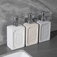 3-pack ceramic dish soap bottle dispensers with matte sand-dot finish and chrome pumps on kitchen countertop.