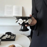 Lumière Ceramic 3D Rose Jewelry and Decor Bowl with white flower petals on black pedestal base.
