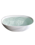 Front view of the Abyss Series 59-inch matte white solid surface resin freestanding soaking tub filled with water.