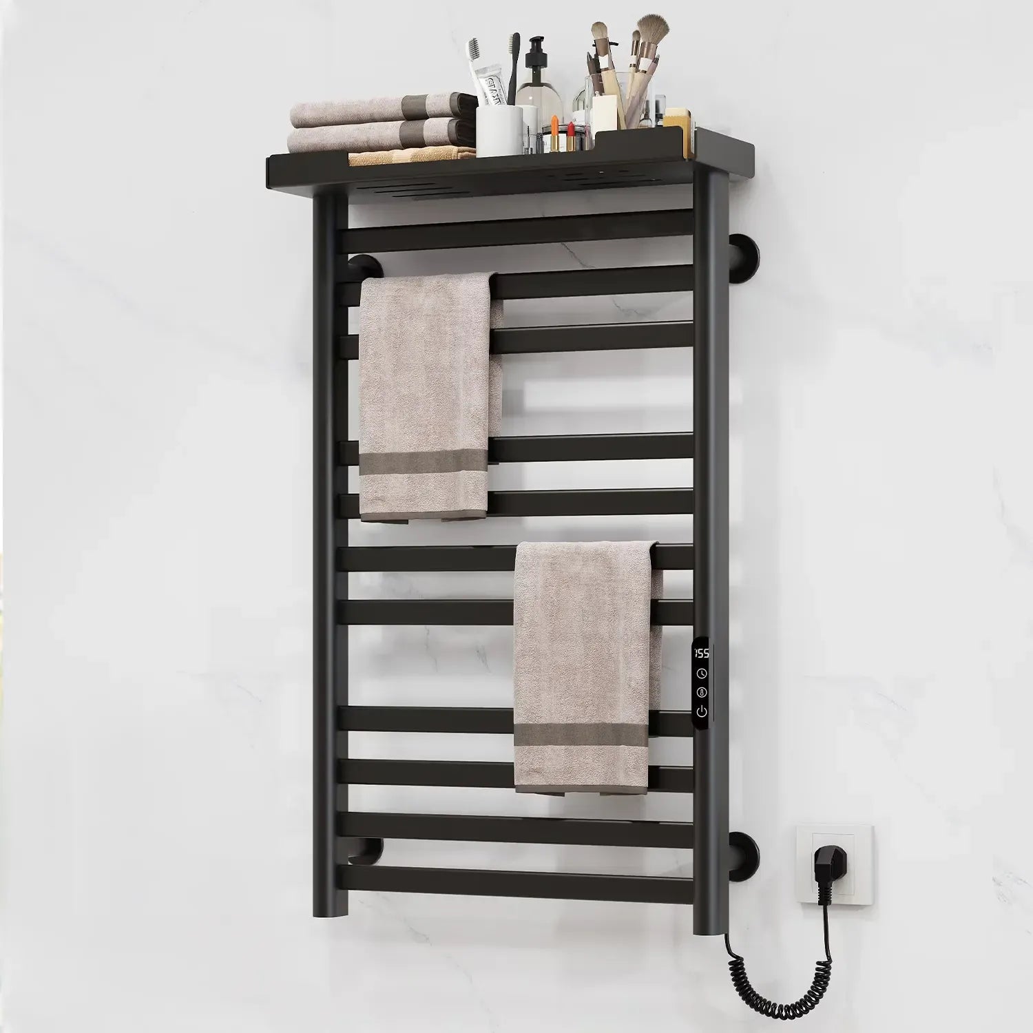 Black electric towel warmer with top storage shelf and LED touch controls mounted on white bathroom wall.
