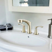 Harbor Series brushed gold widespread faucet installed on bathroom sink, elegant finish