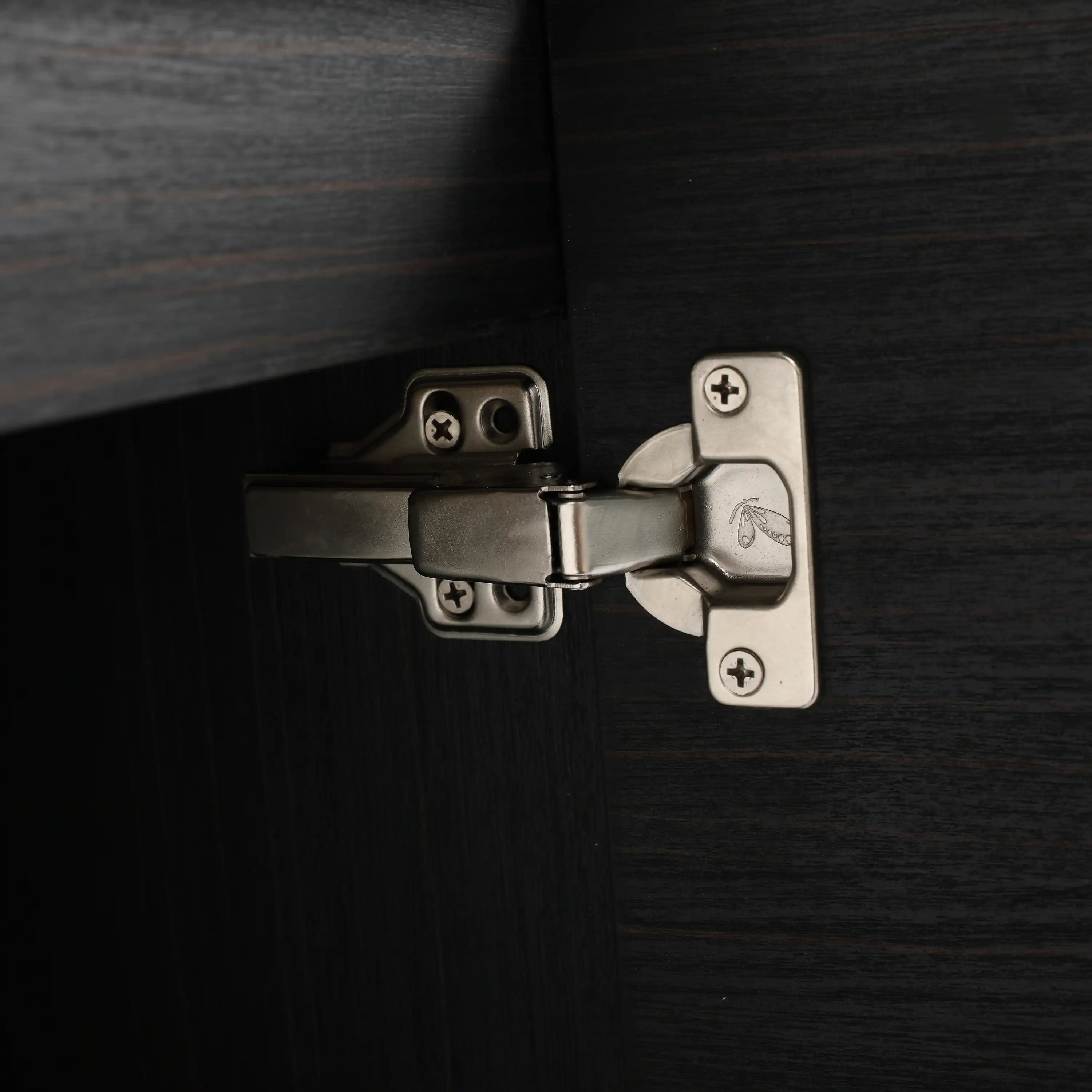 Close-up of metal soft-close hinge on Civetta-Plain Series black bathroom vanity cabinet.