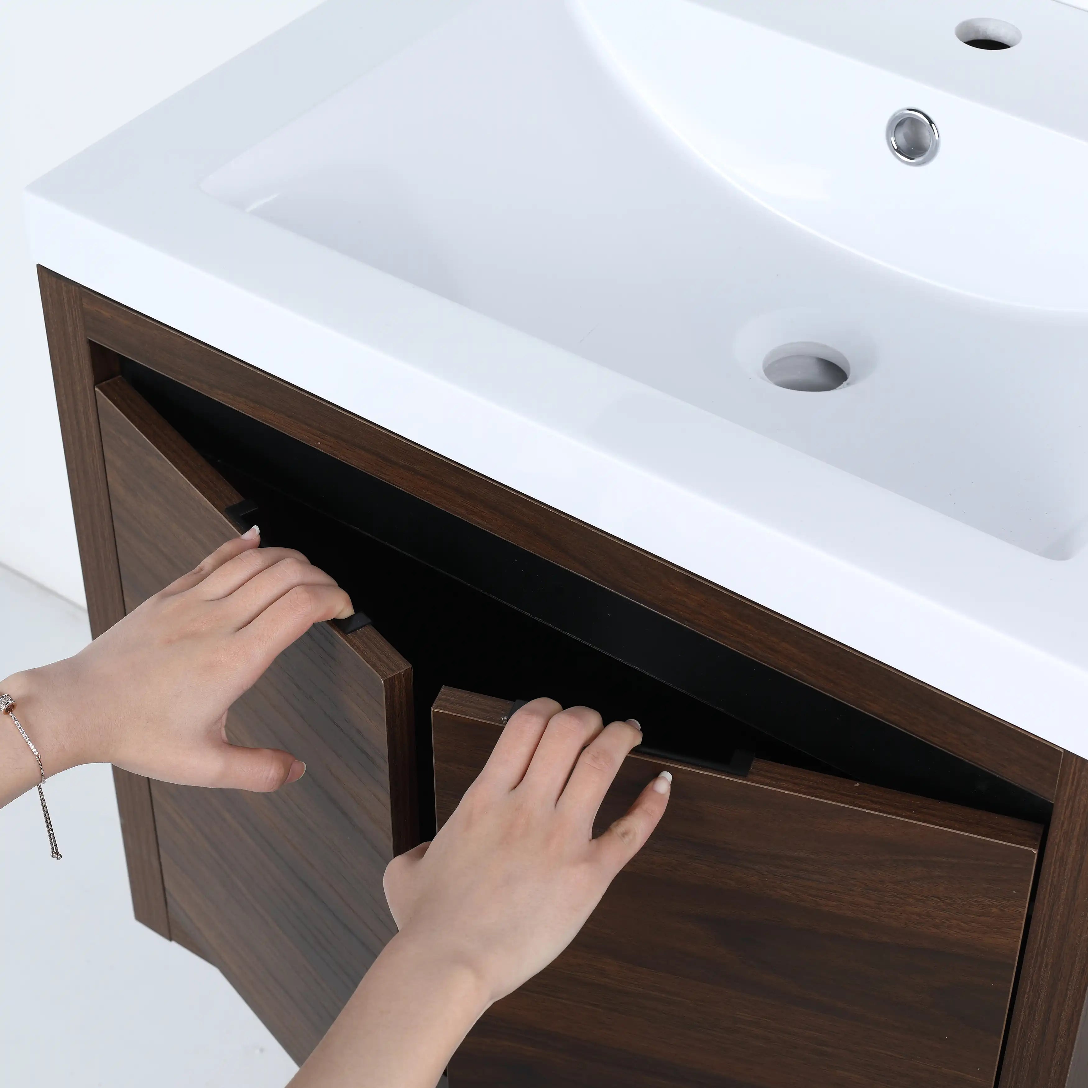 Soft-close double doors with concealed handles on 24 inch walnut finish floating vanity.