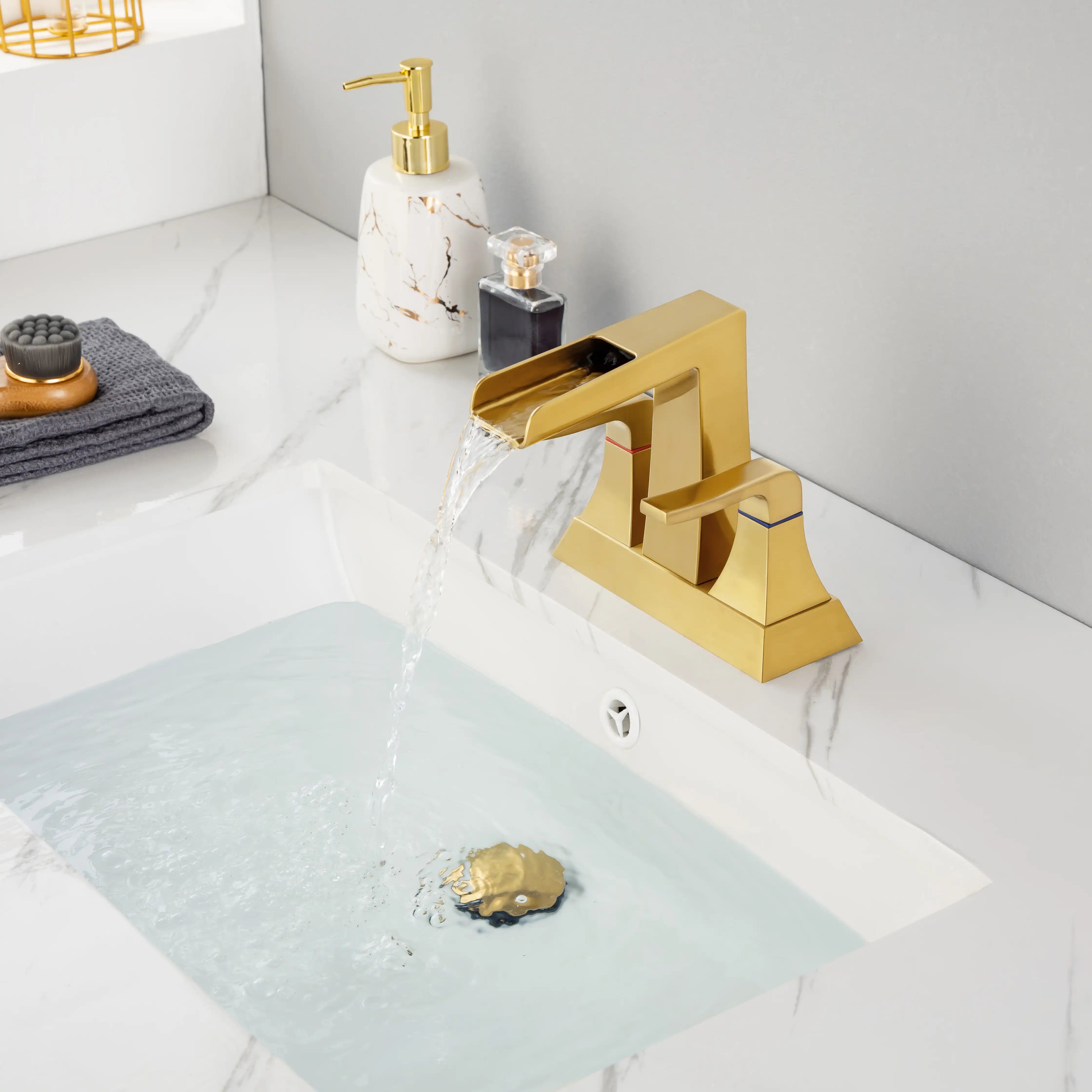 Aurora Series brushed gold widespread sink faucet running water into basin, modern bathroom setting
