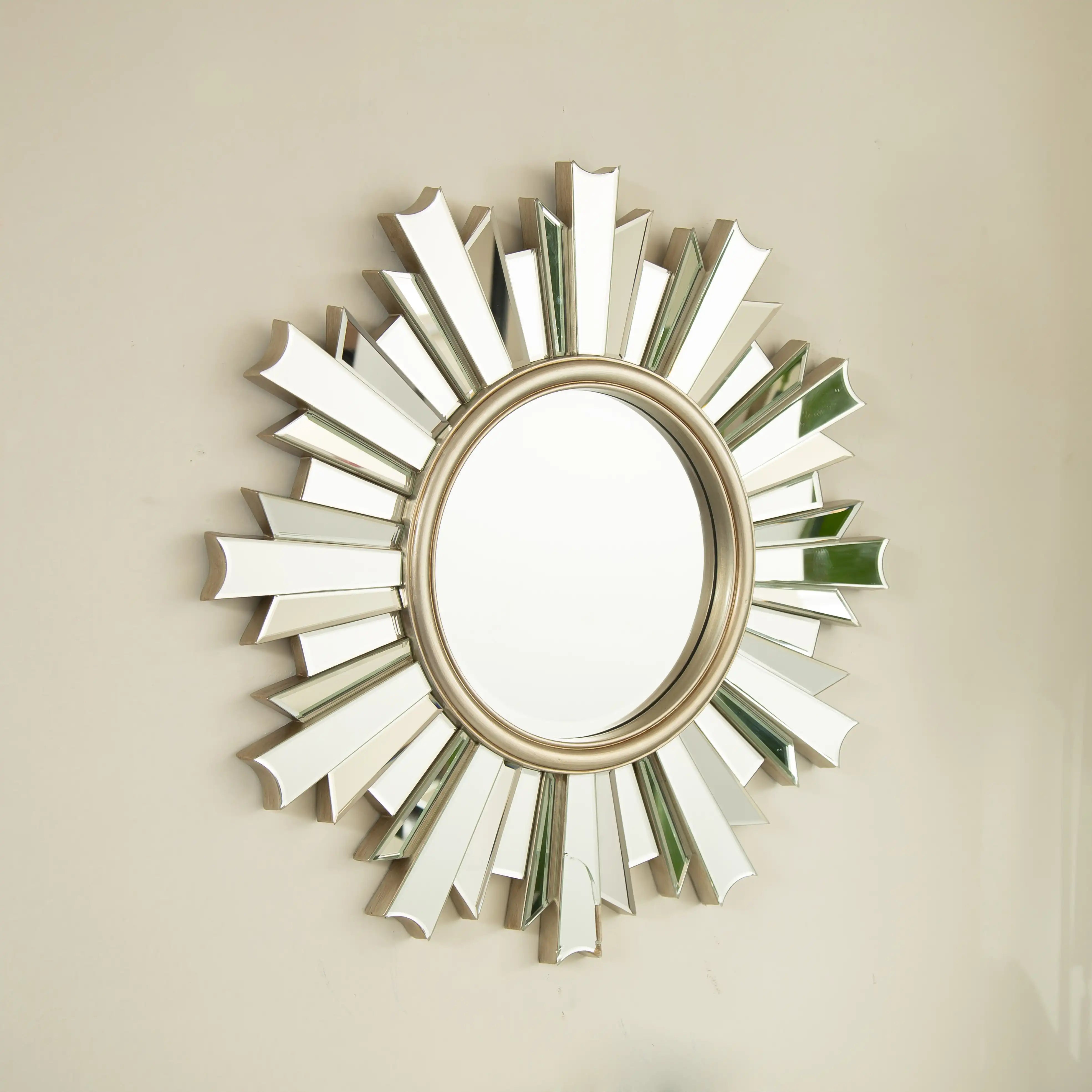 26 inch PU and glass sunburst mirror for bathroom decor shown at an angle | Ace Decor